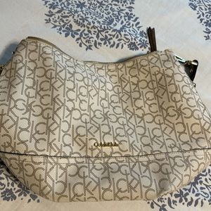 Calvin Klein handbag, beige good condition, has side zipper pocket.
